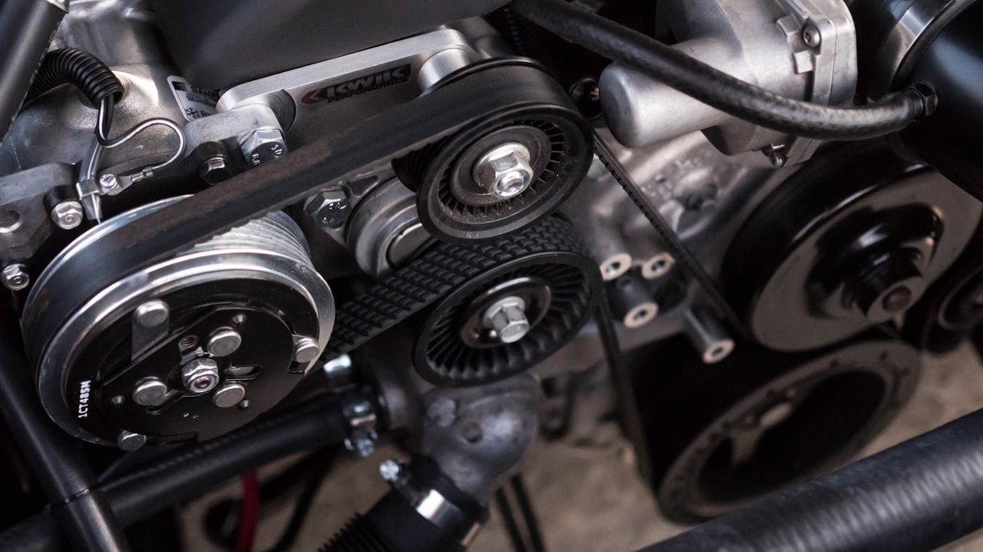 Close-up of belts and pulleys in a classic engine bay